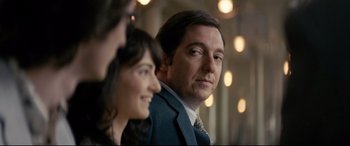 Movie still from “Yves Saint Laurent” (2014), directed by Jalil Lespert – A man and a woman looking at the camera; Close Up shot, Over the shoulder angle