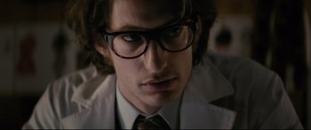 Movie still from “Yves Saint Laurent” (2014), directed by Jalil Lespert – A person wearing glasses and a white coat; Close Up shot, Low angle