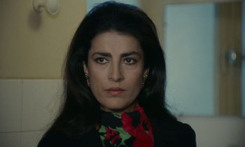 Movie still from “Z” (1969), directed by Costa-Gavras – A person with long black hair; Close Up shot, Low angle
