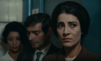 Movie still from “Z” (1969), directed by Costa-Gavras – A man and a woman are looking at the camera; Close Up shot, Over the shoulder angle