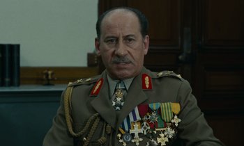 Movie still from “Z” (1969), directed by Costa-Gavras – A person wearing a uniform and medals; Close Up shot, Low angle