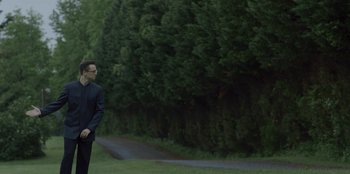 A man standing in front of some trees