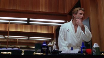 Movie still from “Zero Effect” (1998), directed by Jake Kasdan – A man in a white bathrobe brushing his teeth; Medium shot, Low angle