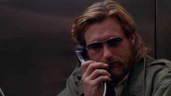 Movie still from “Zero Effect” (1998), directed by Jake Kasdan – A person talking on a cell phone; Close Up shot, Low angle