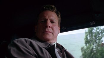 Movie still from “Zero Effect” (1998), directed by Jake Kasdan – A person wearing a suit and tie; Close Up shot, Low angle