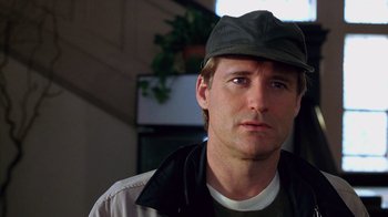 Movie still from “Zero Effect” (1998), directed by Jake Kasdan – A person wearing a hat; Close Up shot, Low angle