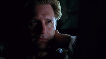 Movie still from “Zero Effect” (1998), directed by Jake Kasdan – A person in a dark room; Close Up shot, Low angle