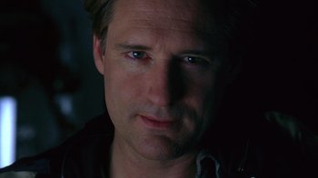 Movie still from “Zero Effect” (1998), directed by Jake Kasdan – A man's face in the dark; Close Up shot, Low angle