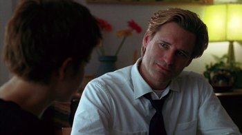 Movie still from “Zero Effect” (1998), directed by Jake Kasdan – A man wearing a white dress shirt and a blue tie; Close Up shot, Over the shoulder angle