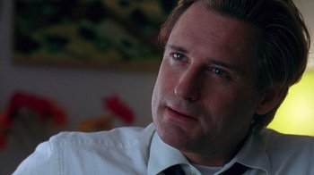 Movie still from “Zero Effect” (1998), directed by Jake Kasdan – A person wearing a shirt and tie; Close Up shot, Low angle