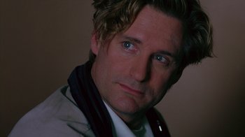 Movie still from “Zero Effect” (1998), directed by Jake Kasdan – A person wearing a white shirt; Close Up shot, Low angle