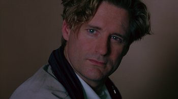 Movie still from “Zero Effect” (1998), directed by Jake Kasdan – A person wearing a white shirt; Close Up shot, Low angle