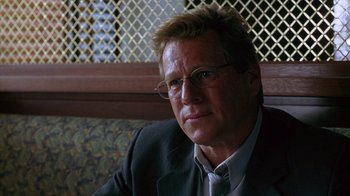 Movie still from “Zero Effect” (1998), directed by Jake Kasdan – A person wearing a suit and tie; Close Up shot, Over the shoulder angle