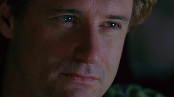Movie still from “Zero Effect” (1998), directed by Jake Kasdan – A man's face with green eyes; Extreme Close Up shot, Low angle
