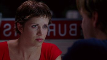 Movie still from “Zero Effect” (1998), directed by Jake Kasdan – A woman in a red shirt talking to a man; Close Up shot, Over the shoulder angle