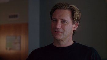 Movie still from “Zero Effect” (1998), directed by Jake Kasdan – A person wearing a black t - shirt; Close Up shot, Low angle