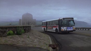 Movie still from “Zero Effect” (1998), directed by Jake Kasdan – A bus is driving down the street in the fog; Extreme Wide shot, Low angle