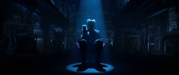 Movie still from “Zoolander” (2001), directed by Ben Stiller – A man sitting in a chair holding a teddy bear; Wide shot, Low angle