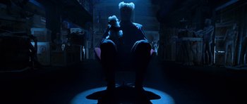 Movie still from “Zoolander” (2001), directed by Ben Stiller – A person sitting in a chair holding a stuffed animal; Wide shot, Low angle