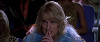 Movie still from “Zoolander” (2001), directed by Ben Stiller – A woman with blonde hair wearing a blue jacket; Close Up shot, Over the shoulder angle