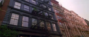 Movie still from “Zoolander” (2001), directed by Ben Stiller – A building with fire escapes on the side of the building; Extreme Wide shot, Low angle