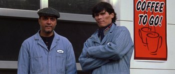 Movie still from “Zoolander” (2001), directed by Ben Stiller – Two men standing next to each other wearing blue work clothes; Medium shot, Low angle