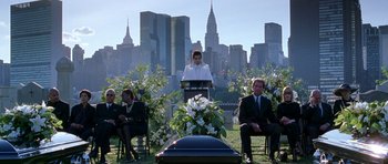 Movie still from “Zoolander” (2001), directed by Ben Stiller – A woman standing in front of an open casket in front of a city skyline; Extreme Wide shot, Over the shoulder angle