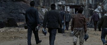 Movie still from “Zoolander” (2001), directed by Ben Stiller – A group of people walking down a dirt road; Wide shot, Low angle