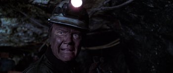 Movie still from “Zoolander” (2001), directed by Ben Stiller – A person wearing a hard hat and holding a wrench; Close Up shot, Low angle