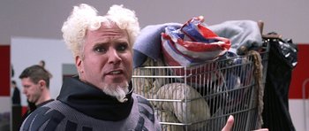 Movie still from “Zoolander” (2001), directed by Ben Stiller – A man in a wig with a basket full of laundry; Close Up shot, Low angle