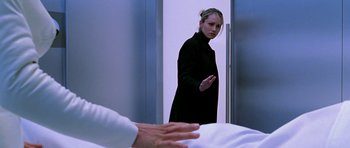 Movie still from “Zoolander” (2001), directed by Ben Stiller – A woman standing in front of an open door; Medium shot, Over the shoulder angle