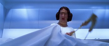 Movie still from “Zoolander” (2001), directed by Ben Stiller – A man in a white shirt is holding a white sheet; Close Up shot, Low angle