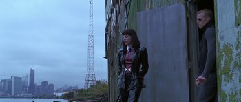Movie still from “Zoolander” (2001), directed by Ben Stiller – A woman standing in front of a tall building; Wide shot, Low angle