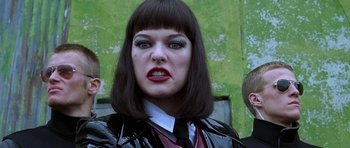 Movie still from “Zoolander” (2001), directed by Ben Stiller – A woman in a black jacket and a black tie; Close Up shot, Low angle