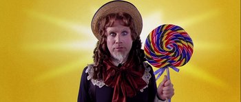 Movie still from “Zoolander” (2001), directed by Ben Stiller – A man dressed up as a woman holding a giant lollipop; Close Up shot, Over the shoulder angle
