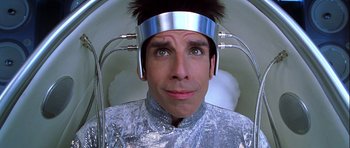 Movie still from “Zoolander” (2001), directed by Ben Stiller – A man in a silver shirt and a silver head piece; Close Up shot, Overhead angle