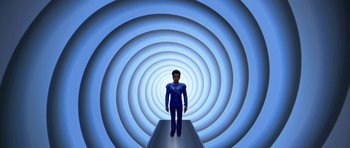 Movie still from “Zoolander” (2001), directed by Ben Stiller – A man standing in front of a blue spiral tunnel; Wide shot, Overhead angle