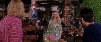 Movie still from “Zoolander” (2001), directed by Ben Stiller – A woman standing in front of a table filled with jars; Wide shot, High angle