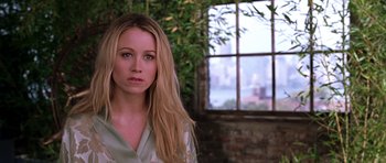 Movie still from “Zoolander” (2001), directed by Ben Stiller – A beautiful young woman with long blonde hair standing in front of a window; Close Up shot, Over the shoulder angle
