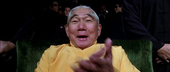 Movie still from “Zoolander” (2001), directed by Ben Stiller – An older man wearing a yellow shirt and a white headband; Close Up shot, Low angle