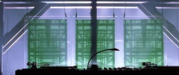 Movie still from “Zoolander” (2001), directed by Ben Stiller – A lamp is lit up in front of a building; Extreme Wide shot, Low angle