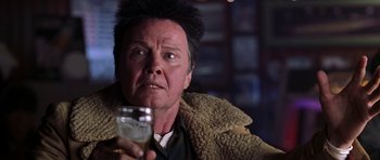 Movie still from “Zoolander” (2001), directed by Ben Stiller – An older man holding a glass in his right hand; Close Up shot, Low angle