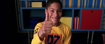 Movie still from “Zoolander” (2001), directed by Ben Stiller – A young boy giving a thumbs up in a yellow shirt; Close Up shot, High angle