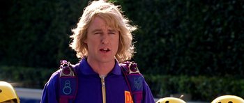 Movie still from “Zoolander” (2001), directed by Ben Stiller – A man with blonde hair and a purple shirt; Close Up shot, Low angle