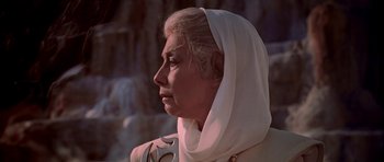 Movie still from “Star Trek: The Motion Picture” (1979), directed by Robert Wise – An older woman wearing a head covering looking off into the distance; Close Up shot, Low angle