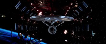 Movie still from “Star Trek: The Motion Picture” (1979), directed by Robert Wise – A star trek ship in the middle of a space station; Extreme Wide shot, Overhead angle