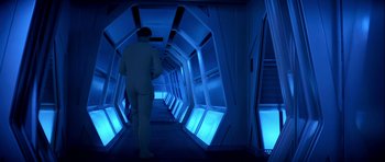 Movie still from “Star Trek: The Motion Picture” (1979), directed by Robert Wise – A man walking down a long hallway in a building; Wide shot, High angle