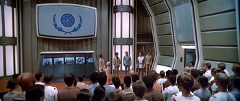 Movie still from “Star Trek: The Motion Picture” (1979), directed by Robert Wise – A group of people standing in front of an audience in front of a building; Wide shot, High angle
