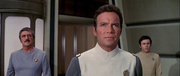 Movie still from “Star Trek: The Motion Picture” (1979), directed by Robert Wise – A man in a uniform looking at the camera; Close Up shot, Over the shoulder angle