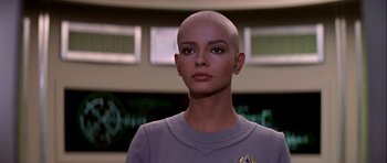 Movie still from “Star Trek: The Motion Picture” (1979), directed by Robert Wise – A woman with a shaved head is standing in front of a window; Close Up shot, Low angle